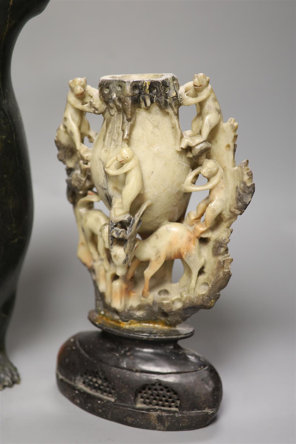 A 19th century Chinese soapstone vase, carved with monkeys, together with an inuit stone carving of a penguin, height 41cm